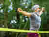 A man ealted as he crosses the finsish line at a running event 