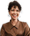 A cut out of a young professional woman wearing a brown blouse and smiling at the camera 