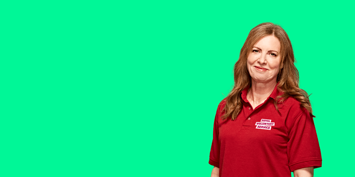 Portrait of volunteer Jacqui against an green background 