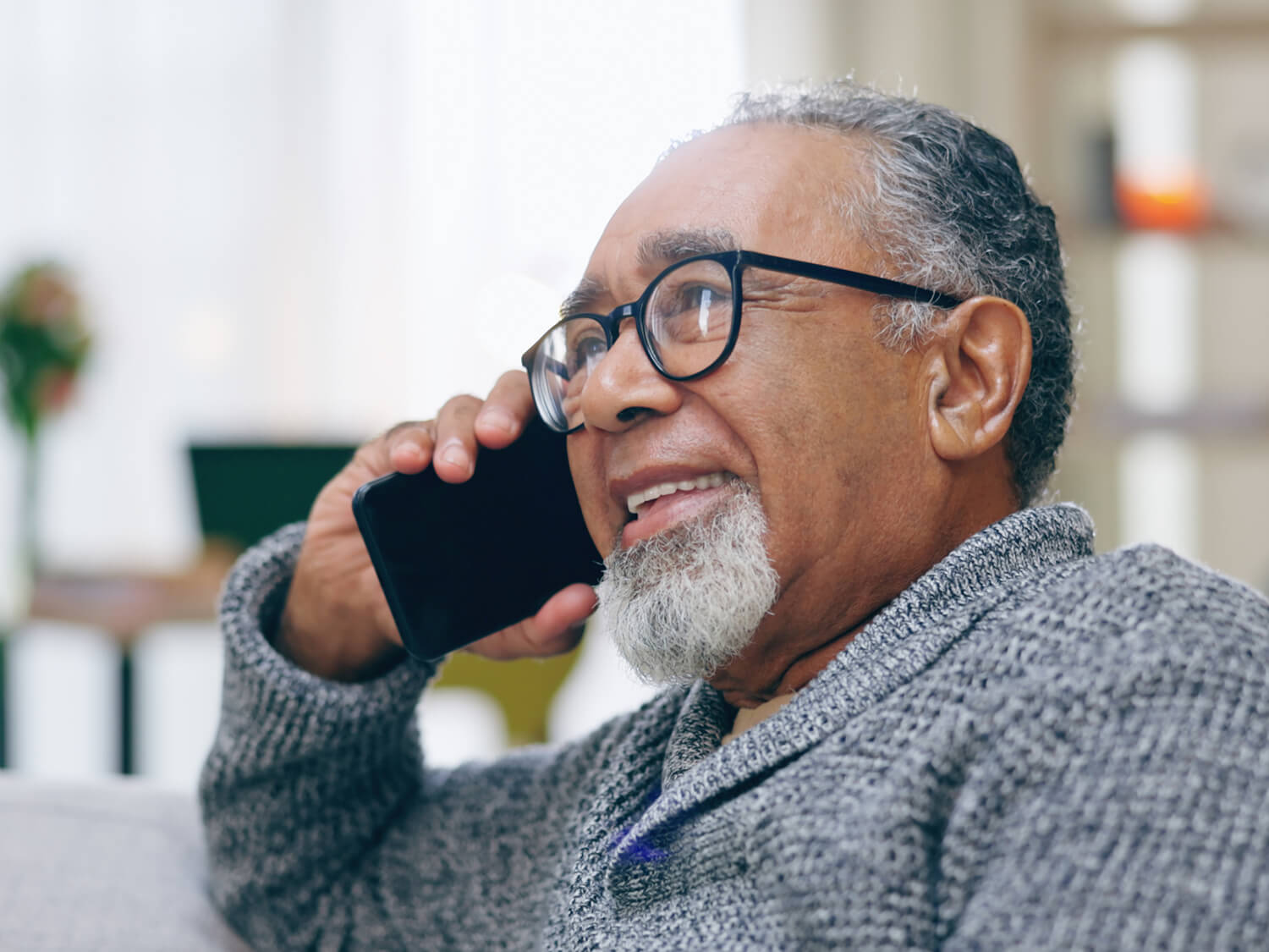 A man on the telephone smiling