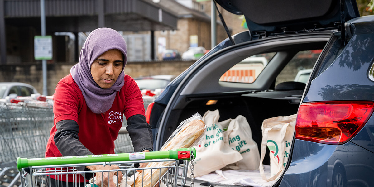A volunteer loading the car after shopping 