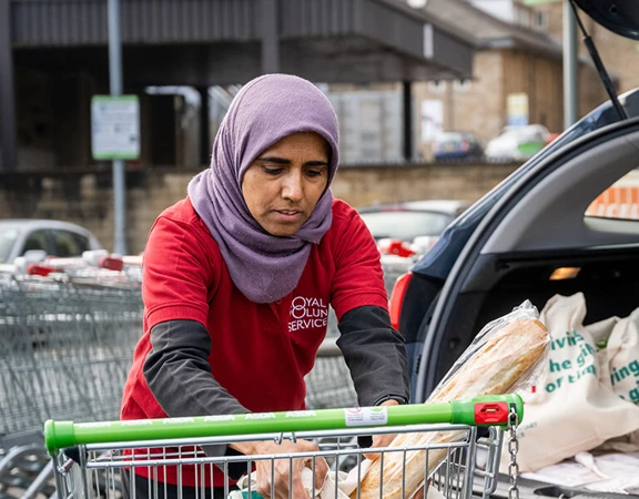 A volunteer loading the car after shopping