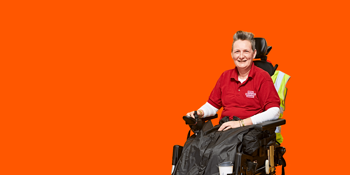 Portrait of volunteer Elaine against an orange background 