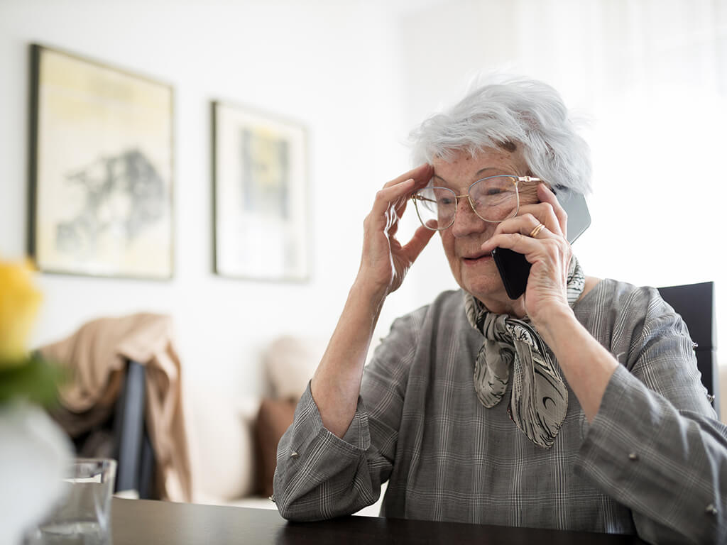 An older woman on the phone looking concerned