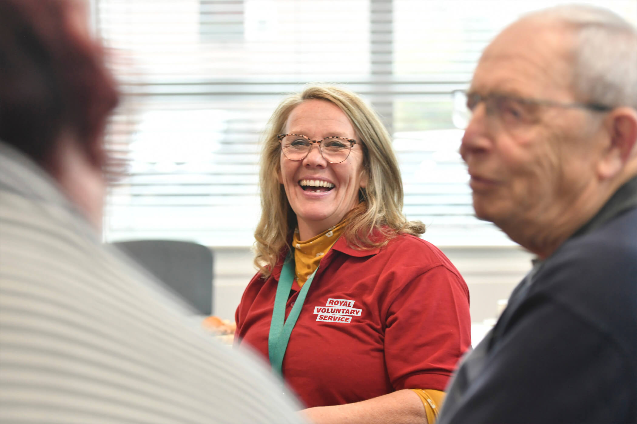 A Royal Voluntary Service volunteer at a club with 2 clients
