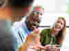 A group of work colleagues laughing together