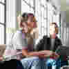A woman sitting in a meeting at work and smiling 