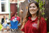 A young woman out volunteering who is smiling while wearing a Royal Voluntary Service tshirt