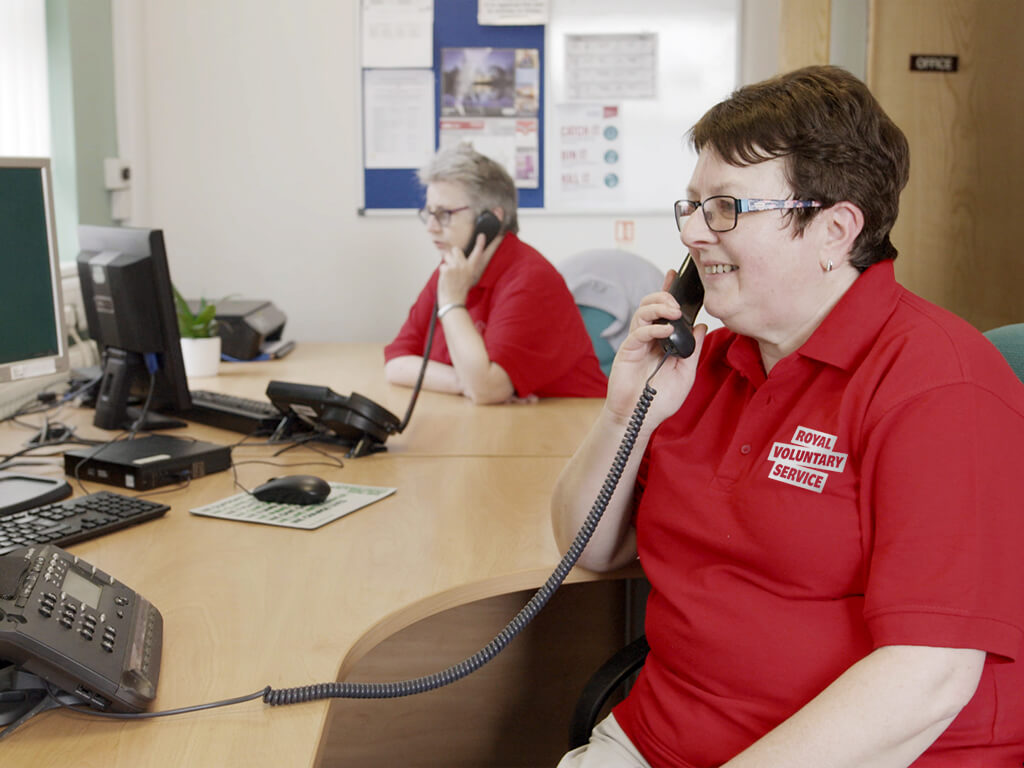 A Royal Voluntary service volunteer on the phone