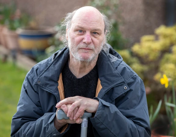 A Royal Voluntary Service client with a walking stick