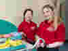 Two volunteers pushing a trolley with snacks and refreshments on a hospital ward 