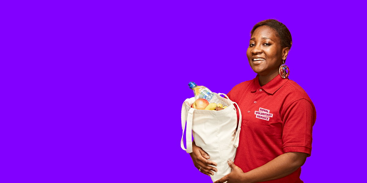 Portrait of volunteer Amma against an purple background 