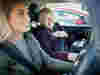 An older woman being driven to an appointment by a volunteer
