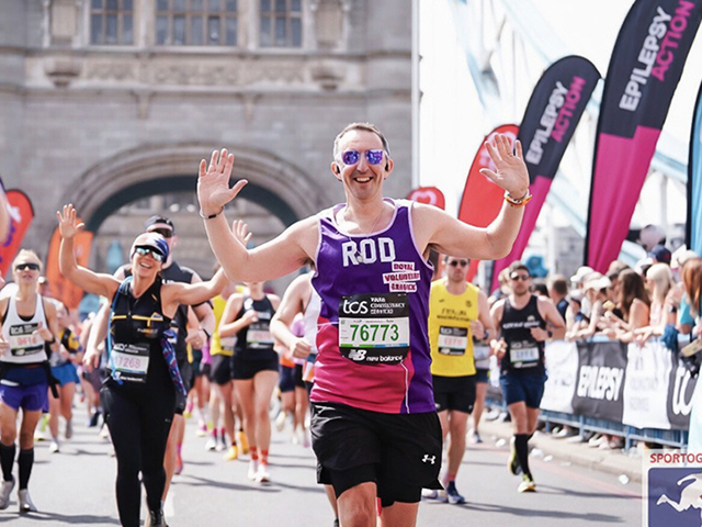 Royal Voluntary service fundraiser Rd running across Tower Bridge at the London Marathon in 2026. 