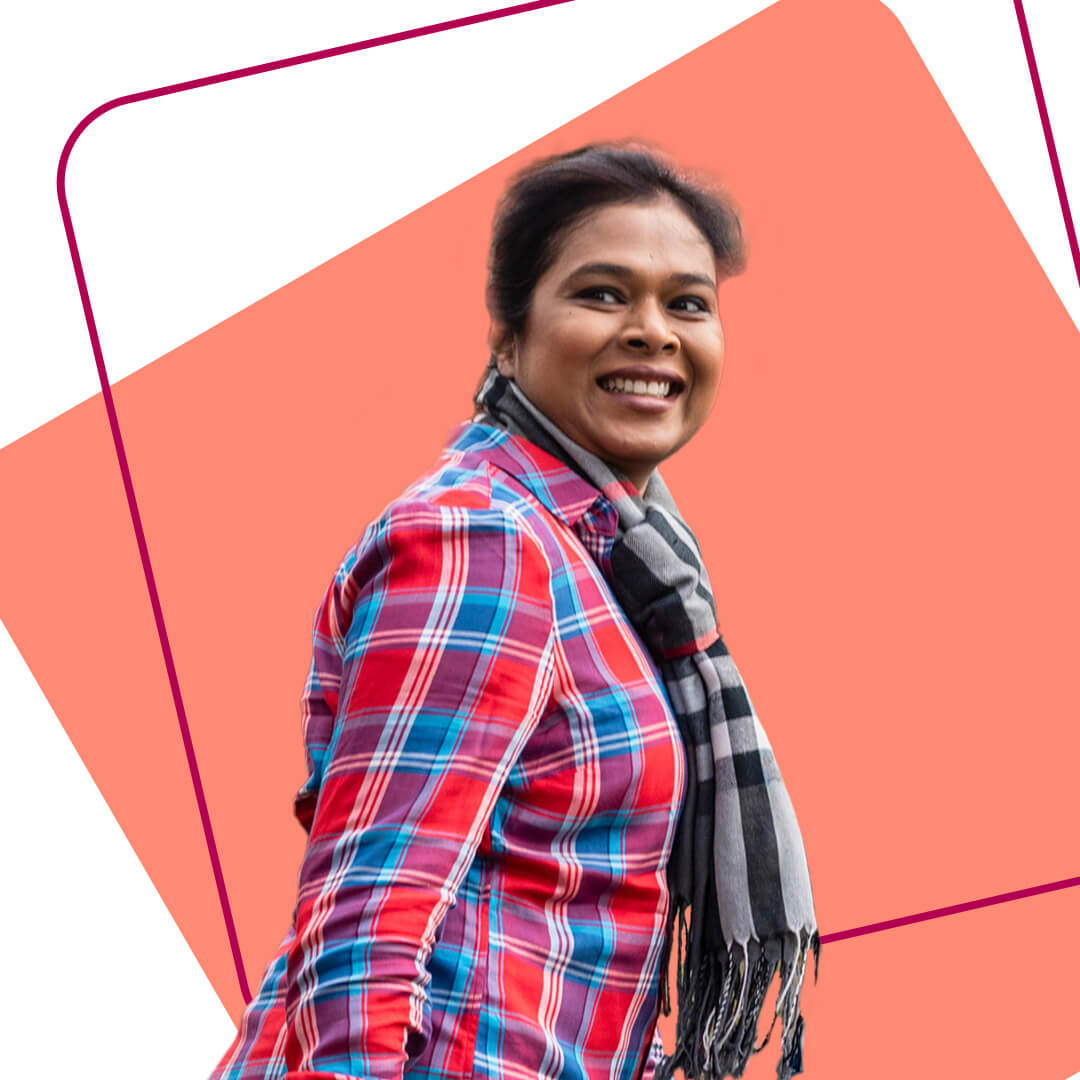 A young volunteer smiling in a cut out image against a light orange background 