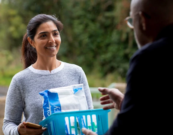A Royal Voluntary Service volunteer delivering a prescription to someone in need
