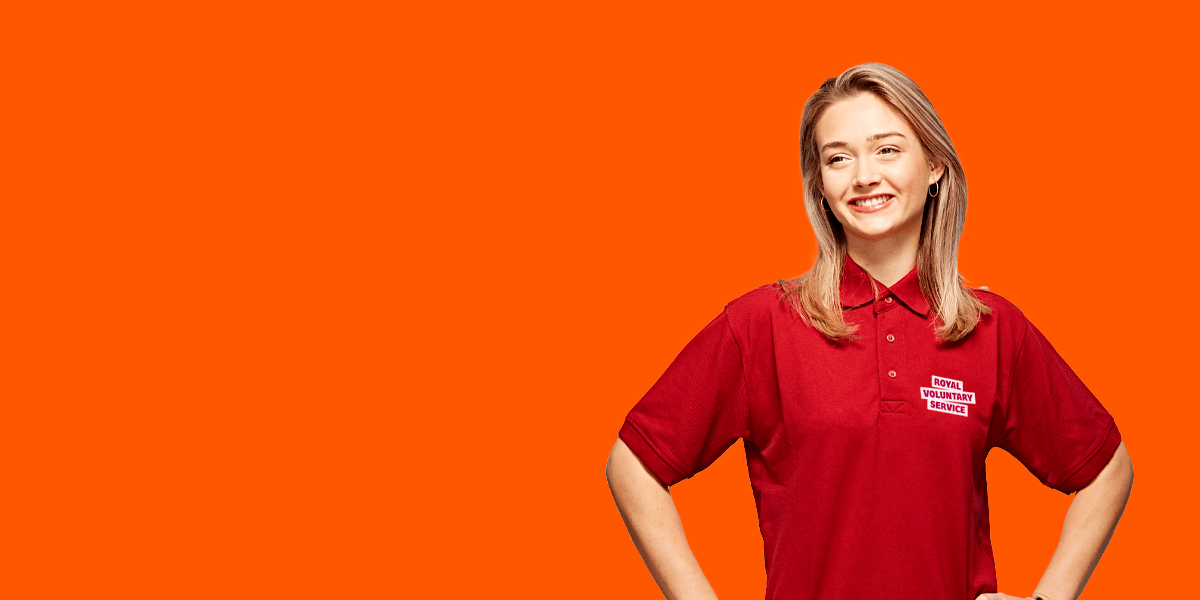Portrait of volunteer Abbey against an orange background 