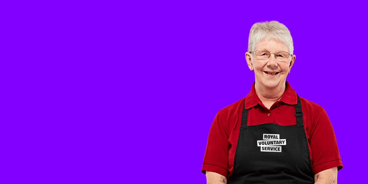 Portrait of volunteer Chris against an purple background 