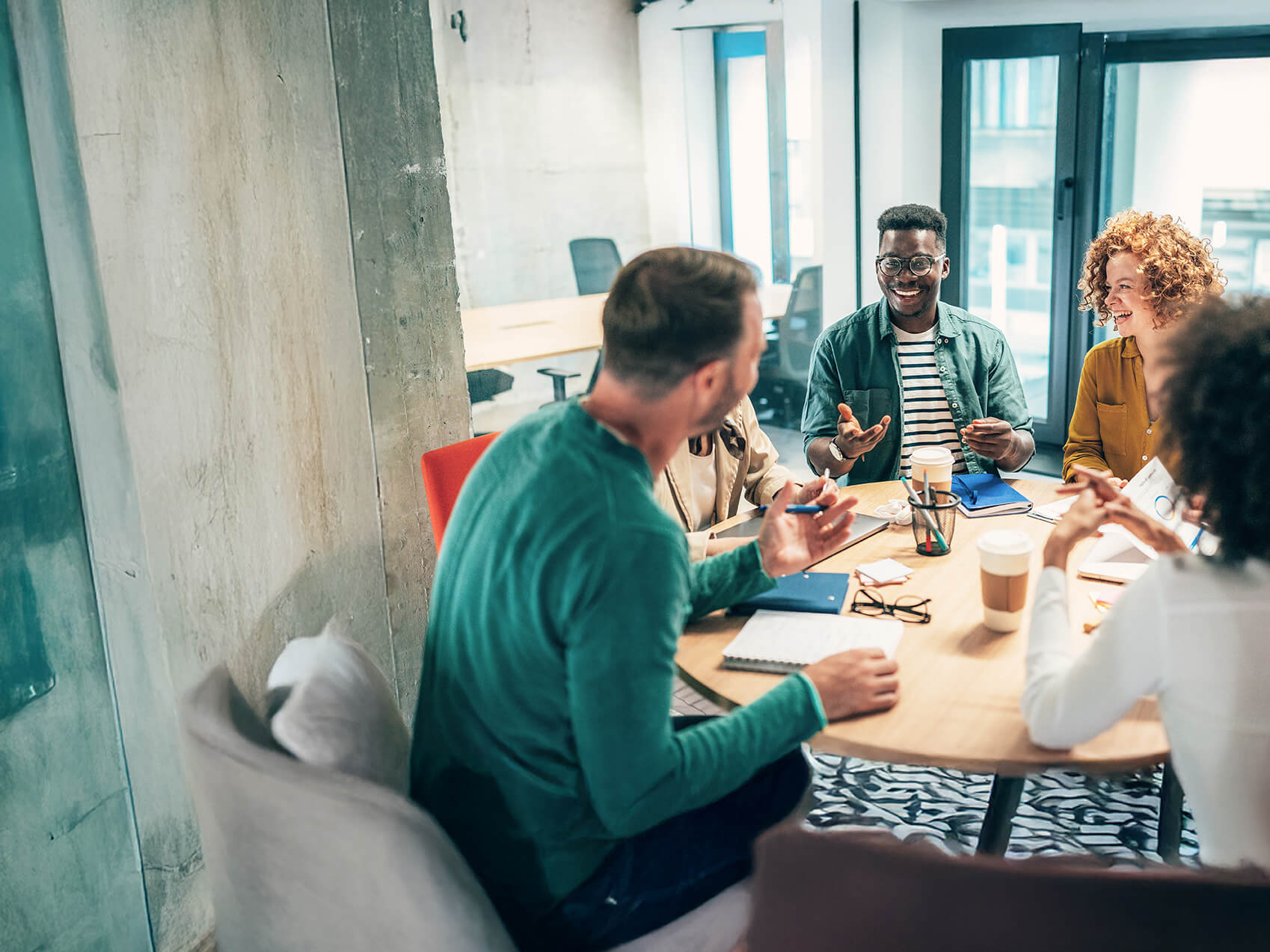A group of professionals workig at a round table in a meeting