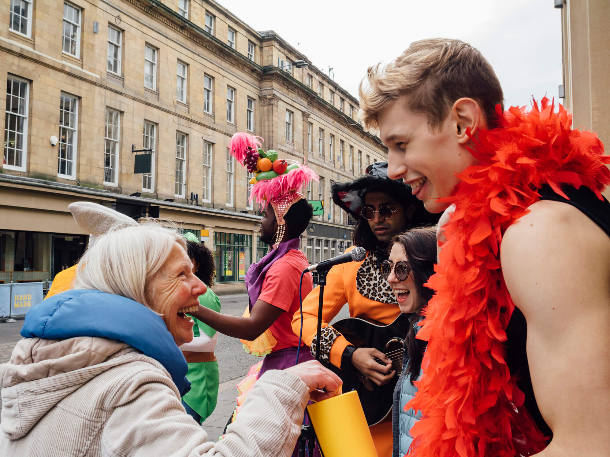 Brightly fancy-dressed fundraisers collecting donations on a city street 