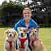 Ellie Simmonds with three dogs as part of the Role of a Lifetime campaign to inspire volunteering