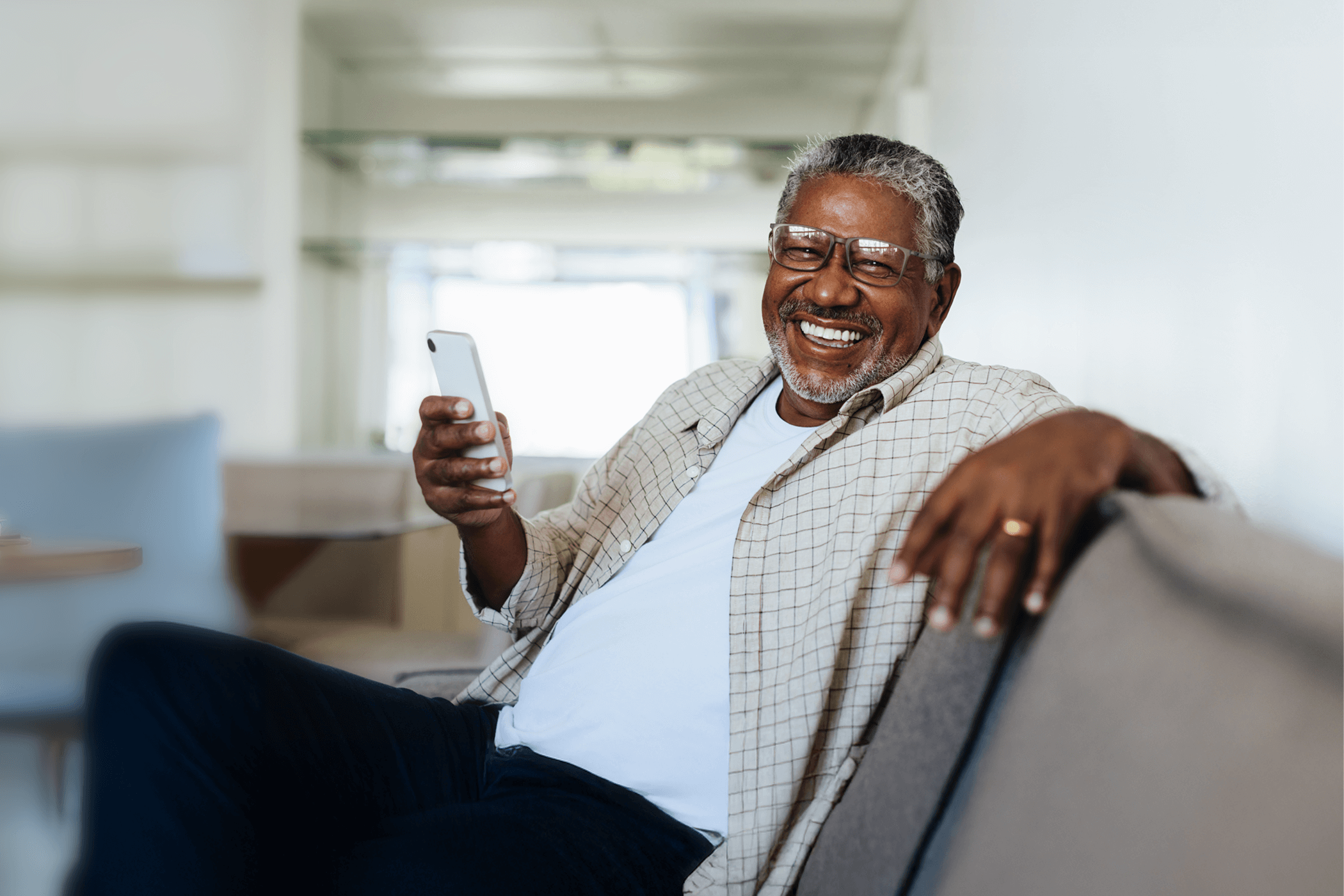 A happy old man waiting for a telephone call
