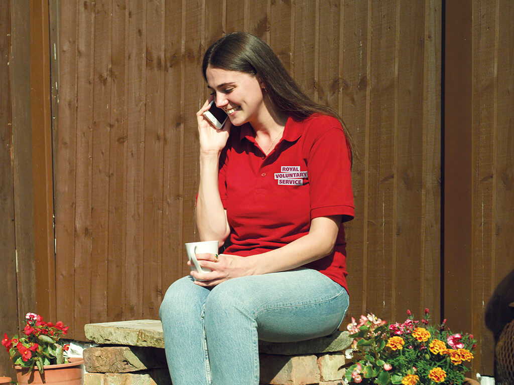 A young volunteer on the phone to a client offering company and support 