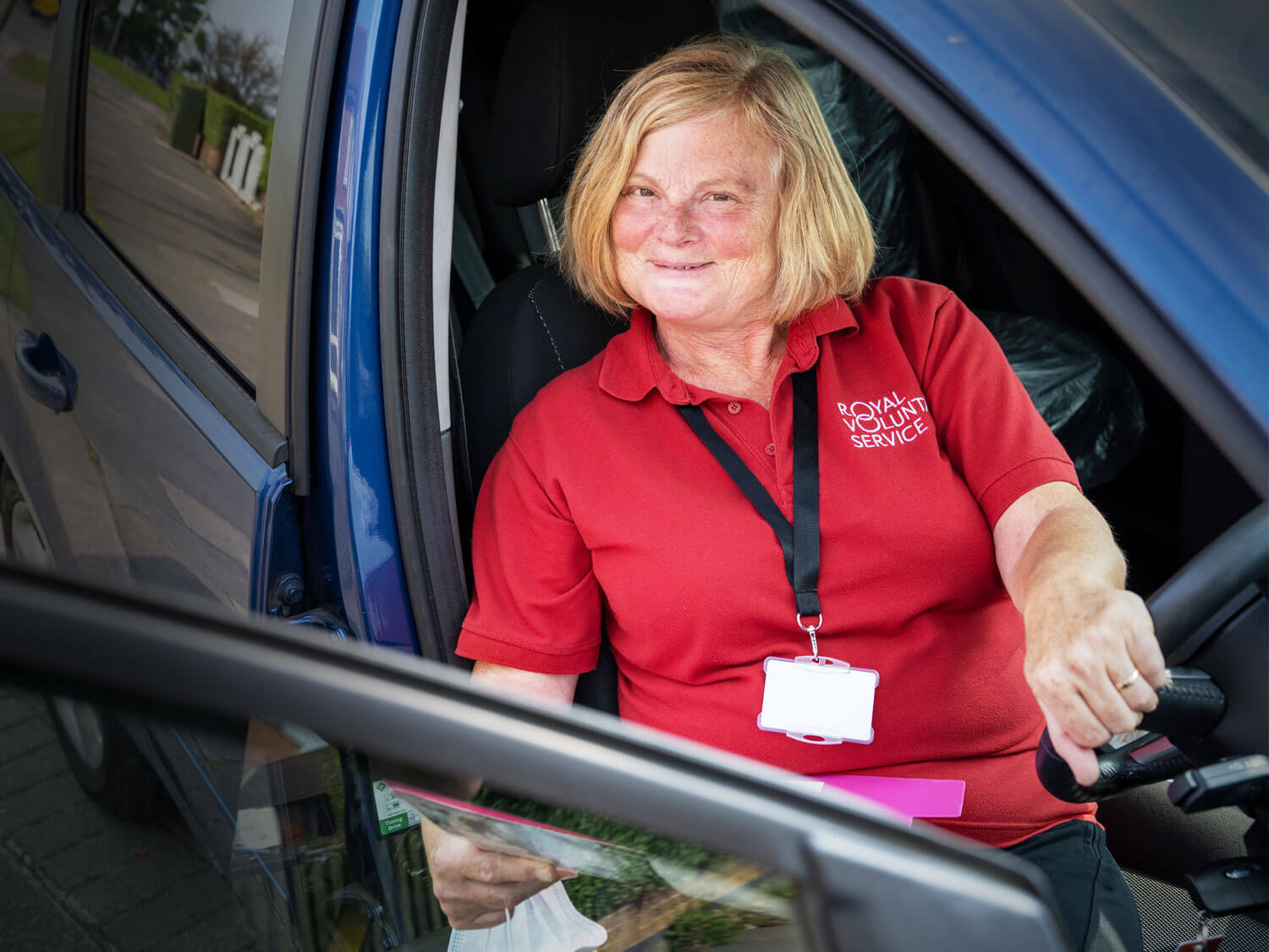 Royal Voluntary Service transport volunteer sat in her car