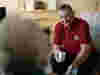 A Royal Voluntary Service Volunteer keeping an older person company in their home