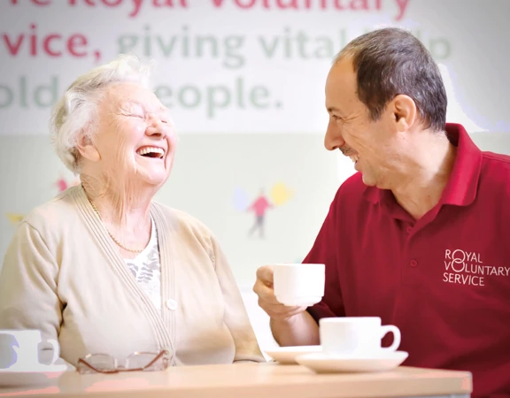 Joyce with a Royal Voluntary Service volunteer enjoying a cup of tea
