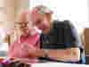 Two older men socialising at a community centre