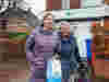A female volunteer supporting an older person to collect a prescription 