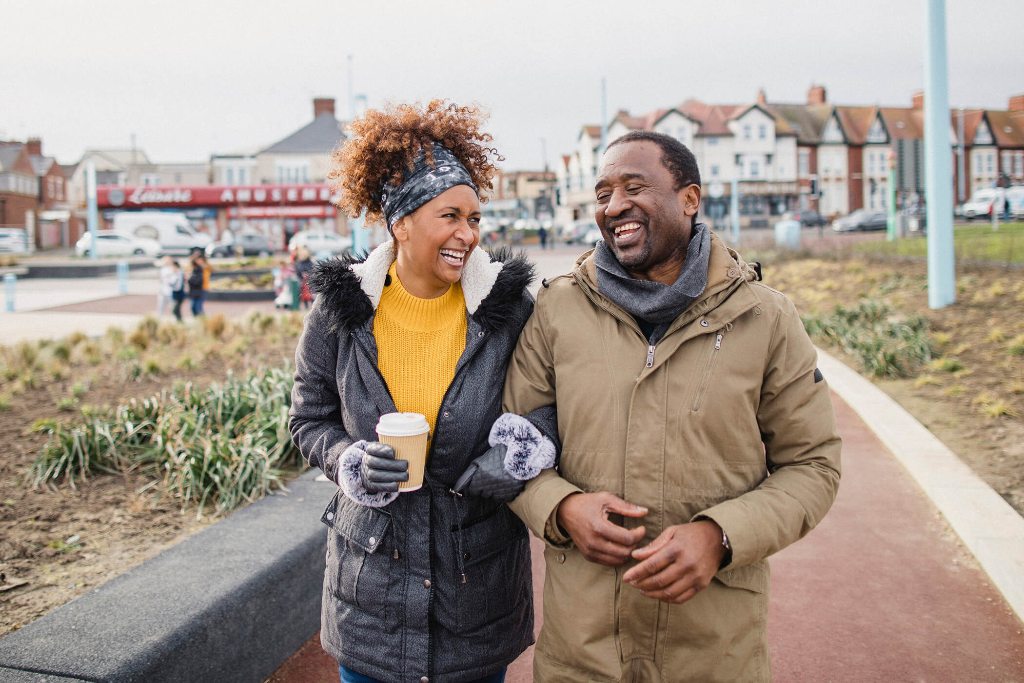 A man and a woman waking arm in arm on a autumn day 
