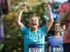 A woman cheering at completing a cahrity fundraiser for Royal Voluntary Service