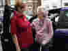 A Royal Voluntary Service volunteer supporting an older lady home from a stay in hospital 