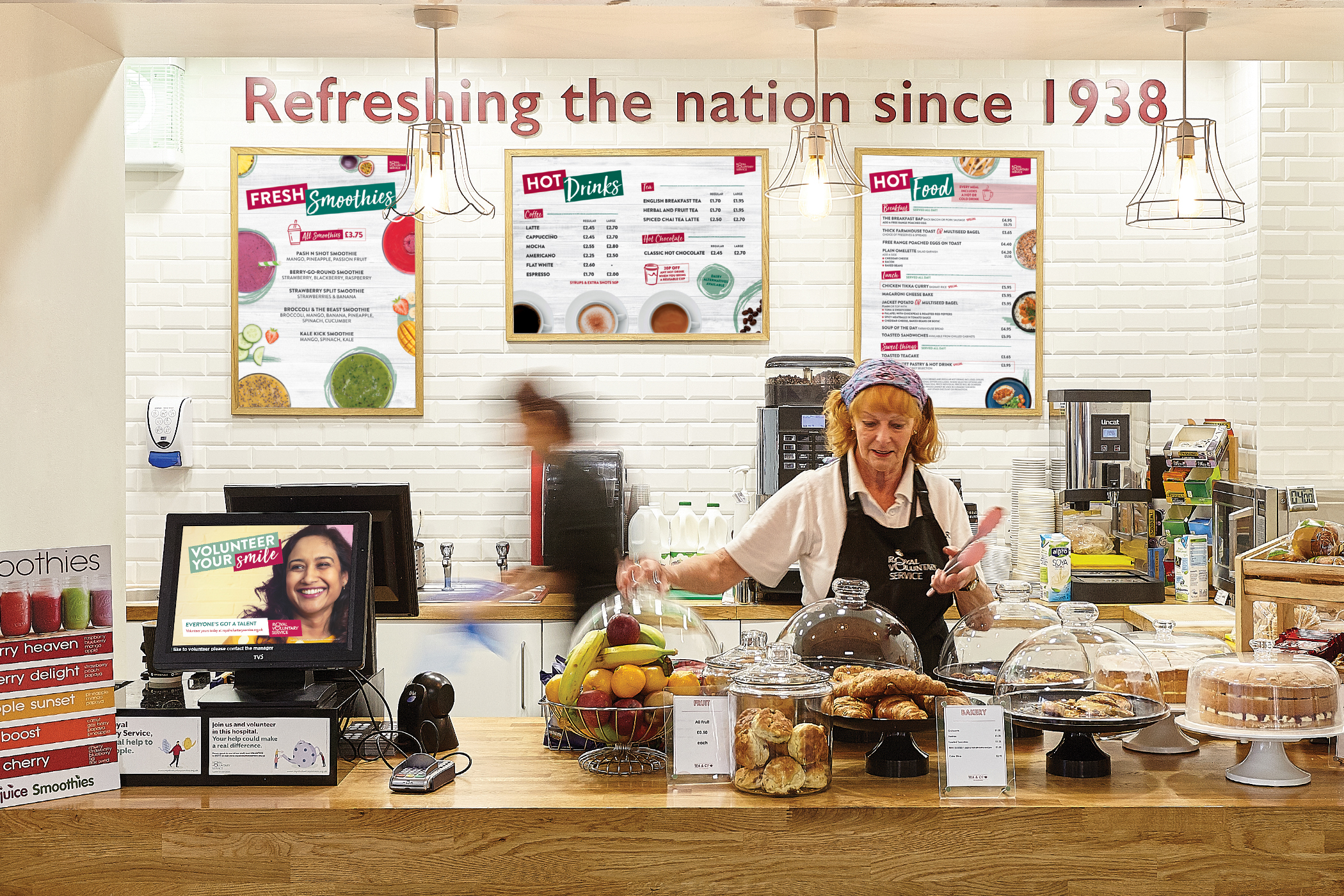 Royal Voluntary Service volunteer serving at the hospital cafe in Kingston, Surrey 